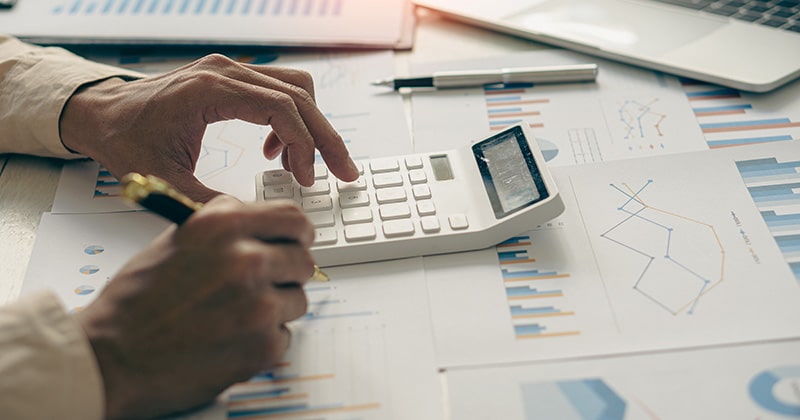 Hands at a calculator.