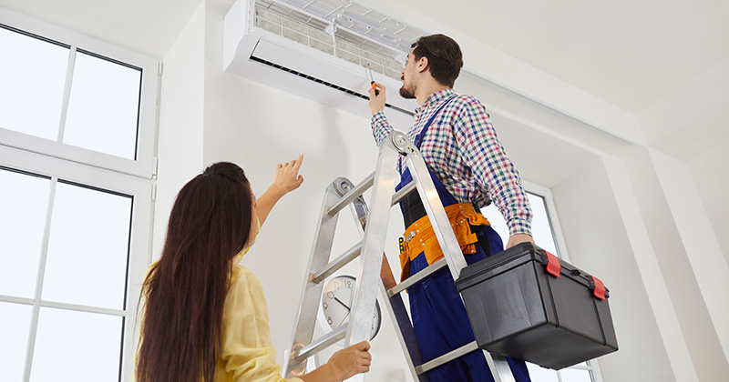 HVAC Worker on the Job with Customer