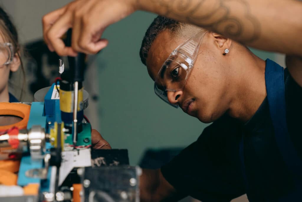 Apprentice electrician practicing hands-on technical skills during supervised electrical training.